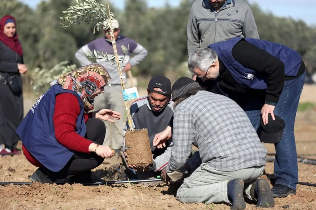An IRFS Global field worker reviewing project plans with community members
